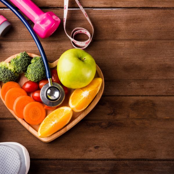 fresh-fruits-vegetables-heart-plate-wood-sports-equipment-doctor-stethoscope